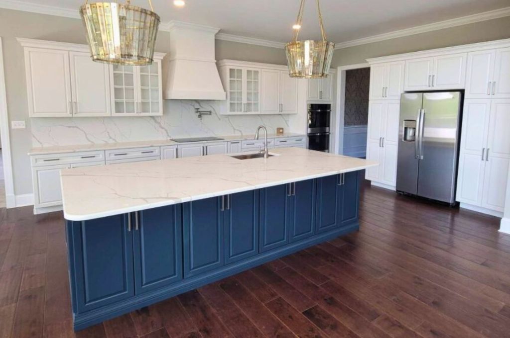 white custom island with navy blue storage cabinet feature